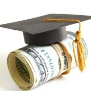 Graduation hat sits atop a roll of cash.